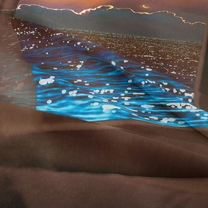 Close-up of bohemian tapestry showing fine fabric texture and moonlit seascape print