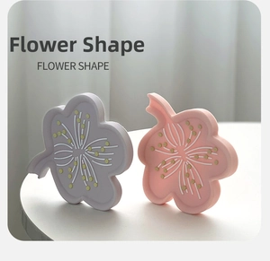Detailed view of flower-shaped silicone soap holders in purple and pink tones