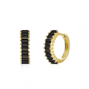 Detailed macro of gold-plated hoop earrings with rectangular black zircon stones