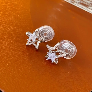 Detail of silver star earrings with zircon inlay and soft-padded clip-on closure