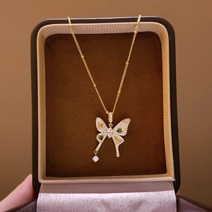 Macro detail of golden butterfly necklace with colorful zircon stones in jewelry box