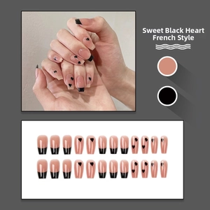 Detail view of pink french tip press-on nails with black hearts and 24-piece full set layout