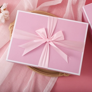 Pink rectangular gift box with satin ribbon bow and elegant floral decoration