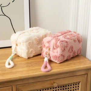 Sweet plush makeup bags with 3D heart patterns in beige and pink for travel storage