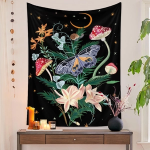 Detail of hanging tapestry with butterfly and mushroom design on a dark wall