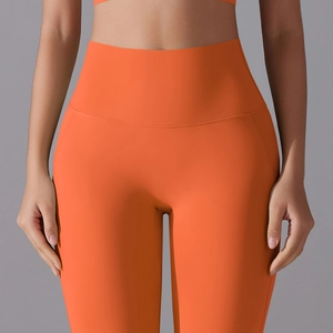 Detailed front view of high-waist seamless orange yoga pants with slimming compression