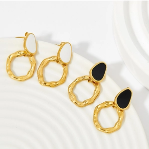 Macro detail of retro gold hoops with colorful enamel drips and textured rock finish