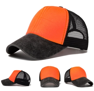 Detail of summer mesh trucker hat with orange foam front and distressed grey brim