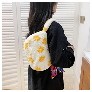 Close-up of white plush shoulder bag with orange daisies and vibrant silk scarf detail