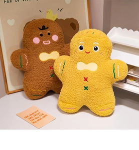 Close-up of plush gingerbread man toy featuring delicate embroidery and soft fabric