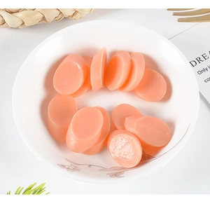Macro detail of realistic miniature pink ham sausage slices in a floral ceramic bowl