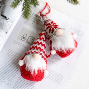 Charming Christmas gnomes plush decor on vintage book background with greenery