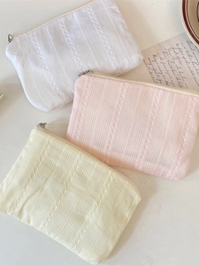 Lace quilted cosmetic bags in white, pink, and beige with stylish vertical stripes