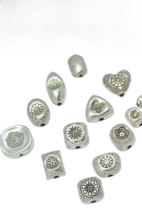 Macro view of vintage Thai floral relief beads in copper alloy for DIY jewelry