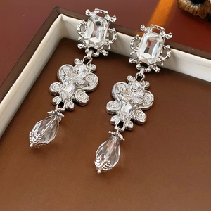 Macro view of vintage silver earrings with crystals and Baroque fringe details