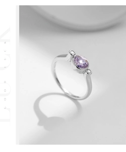 Macro detail of S925 silver ring featuring round purple crystal and polished finish
