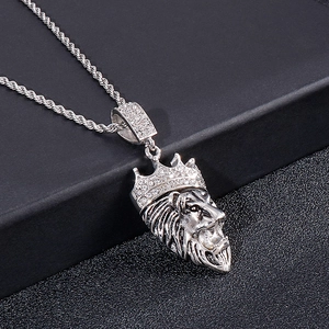 Macro shot of silver hip hop lion head pendant with iced-out crown on a rope chain
