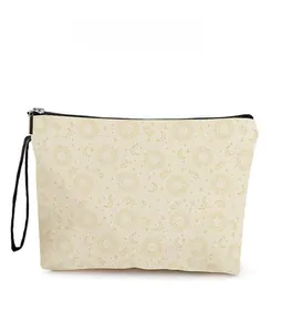 Detail of sun and moon print on canvas makeup bag with black zipper and wristlet strap