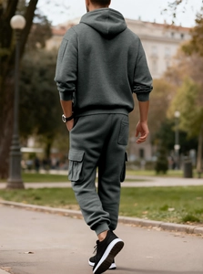 Outdoor street view of dark grey men's hoodie and matching cargo joggers set