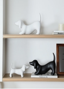Detail of minimalist dachshund ceramic ornaments in black and white matte finish