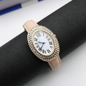 Detail of oval rose gold watch case with crystal bezel and pink crocodile leather strap
