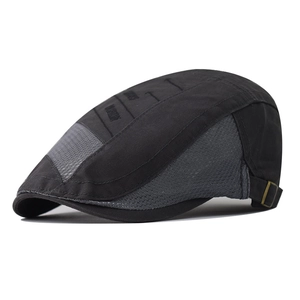 Detail view of breathable grey mesh and black fabric on a stylish flat cap with metal buckle