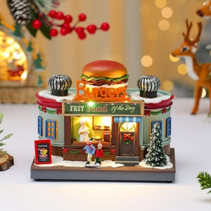 Close-up of a festive burger shop music box with warm LED lights and resin miniatures