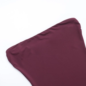 Detail view of smooth maroon fabric texture and stitching on the strapless dress