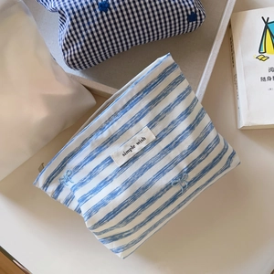 Blue and white striped makeup bag with bow embroidery and simple wish label