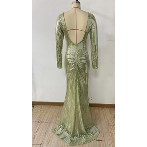 Detail of emerald green sequined evening gown featuring deep V-back and fishtail skirt