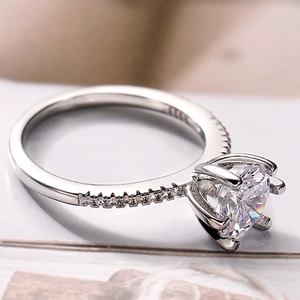 Macro shot of classic six-prong S925 silver ring with side stones and engraving