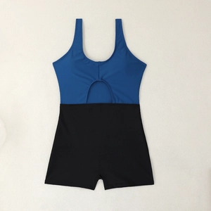 Detail of color-block swimsuit featuring royal blue top with hollow cut-out and black shorts