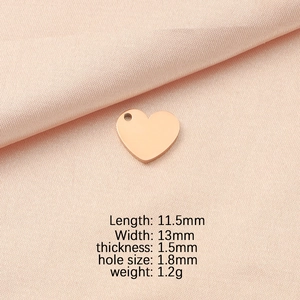 Rose gold heart pendant dimensions: 11.5mm x 13mm with 1.8mm hole on pink fabric