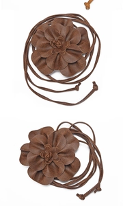 Detailed view of a brown faux leather floral decorative waist belt with intricate cord textures