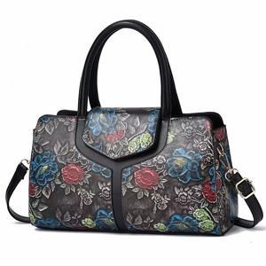 Detail view of floral print Boston bag with vintage grey texture and top handles