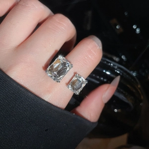 Close-up of geometric silver open ring with dual emerald-cut cubic zirconia stones
