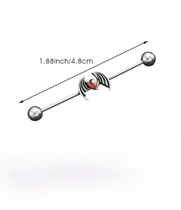 Detail of stainless steel industrial barbell featuring red heart and black bat wings design