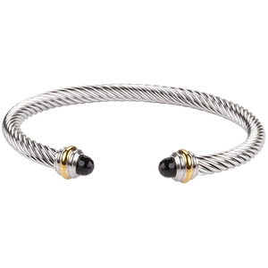 Detail of twisted cable stainless steel bracelet with black faceted stone ends and gold accents