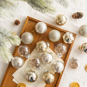 Assorted gold and silver Christmas balls with glitter and crackle finish on wood tray