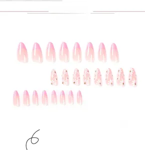 Detail view of almond press-on nails with pink French tips and white daisy floral patterns