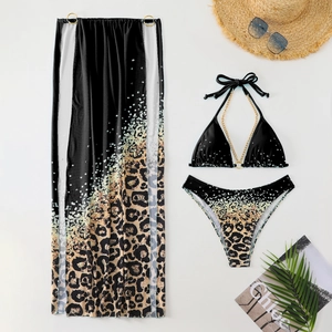 Flat lay of leopard print 3-piece bikini set with chain detail and matching mesh maxi skirt