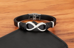 Close-up of stainless steel clasp on a black braided leather infinity symbol bracelet