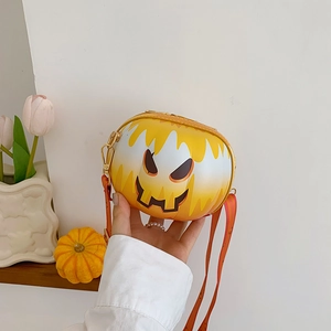 Detail of pumpkin-shaped crossbody bag with smiley face and orange gradient colors