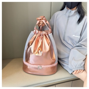 Detail showing the bottom zipper compartment and mesh splicing of the rose gold swim bag