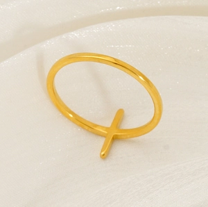 Detail shot of golden 18K plated stainless steel ring with a minimalist cross design