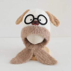 Detail of plush bear-themed winter hat with integrated goggles and cozy ear flaps