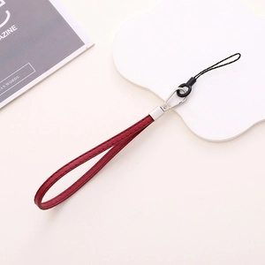 Detail of red PU leather wrist strap with silver metal clasp for phone cases