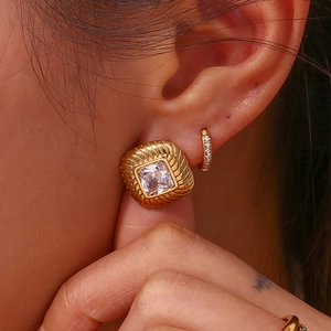 Textured gold square stud earring with zircon stone and matching small hoop on model