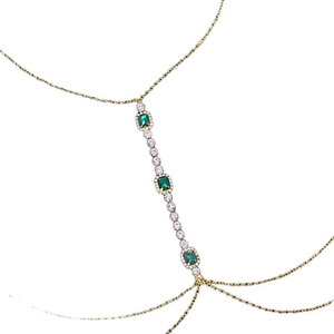 Gold body chain featuring emerald square crystals and layered rhinestone fringe