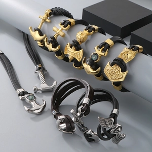 Close-up of vintage leather bracelets with stainless steel anchor and compass charms